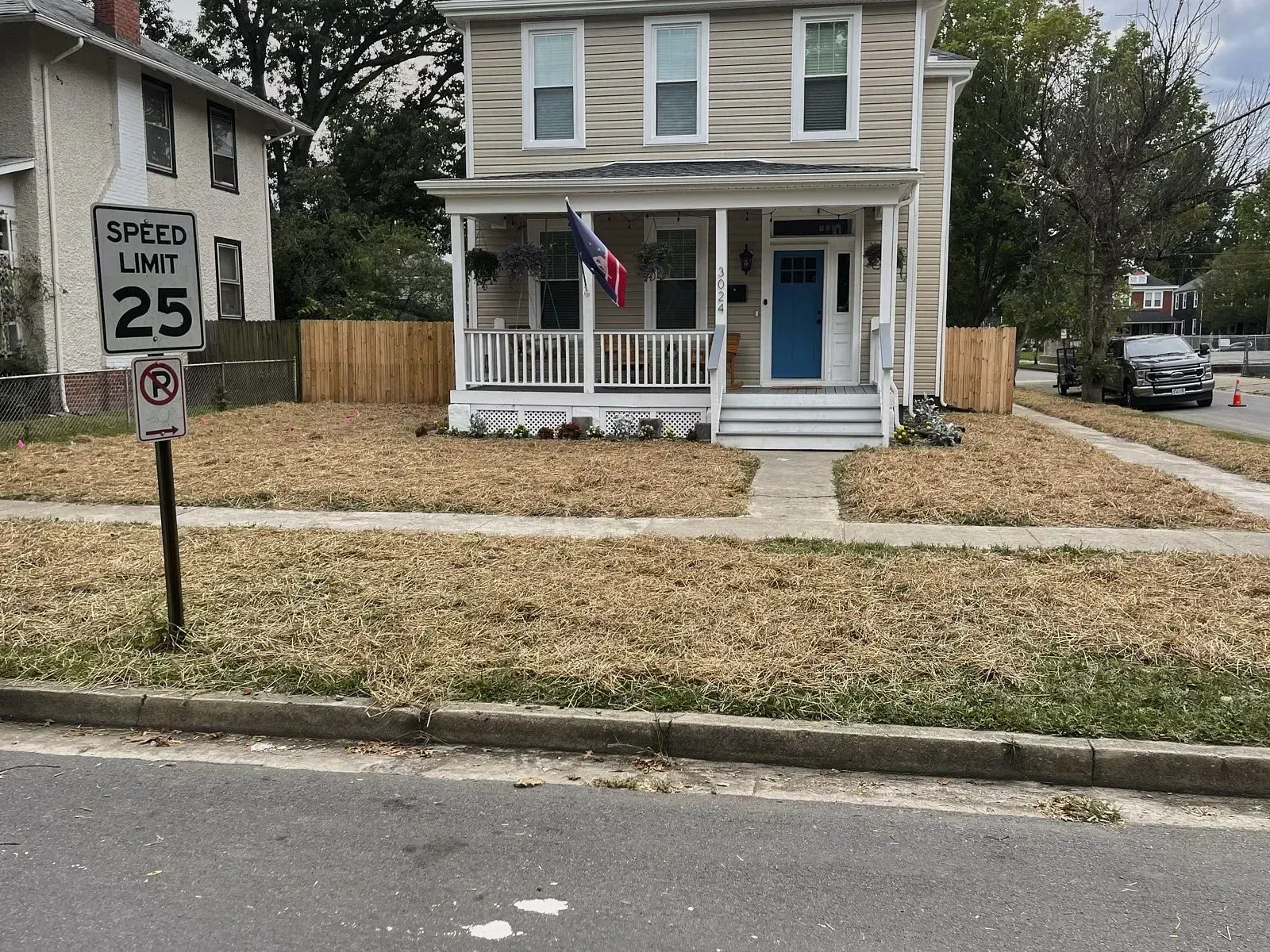 A corner roadside house with a big lawn covered with big yellow grass requires some landscape grading and yard leveling