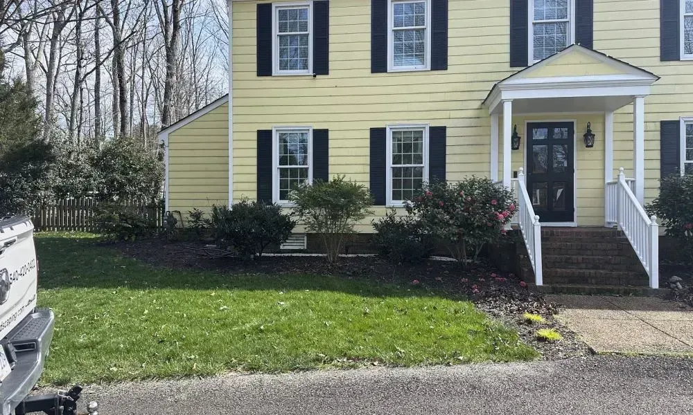 A lawn area outside a corner house with well maintained ground level grass making a very good