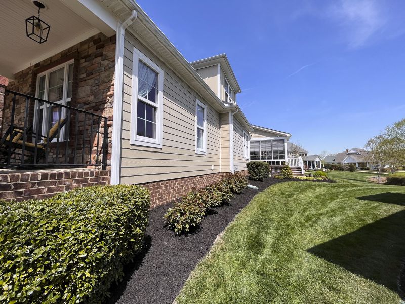 A House With A Garden And Its Corners Mulched Along With Ground Level Grass As A Result Of A Professional Mulch Service